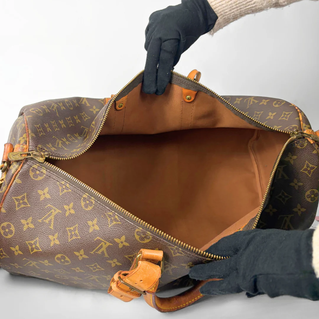 Brown duffel bag with monogram pattern on a white background