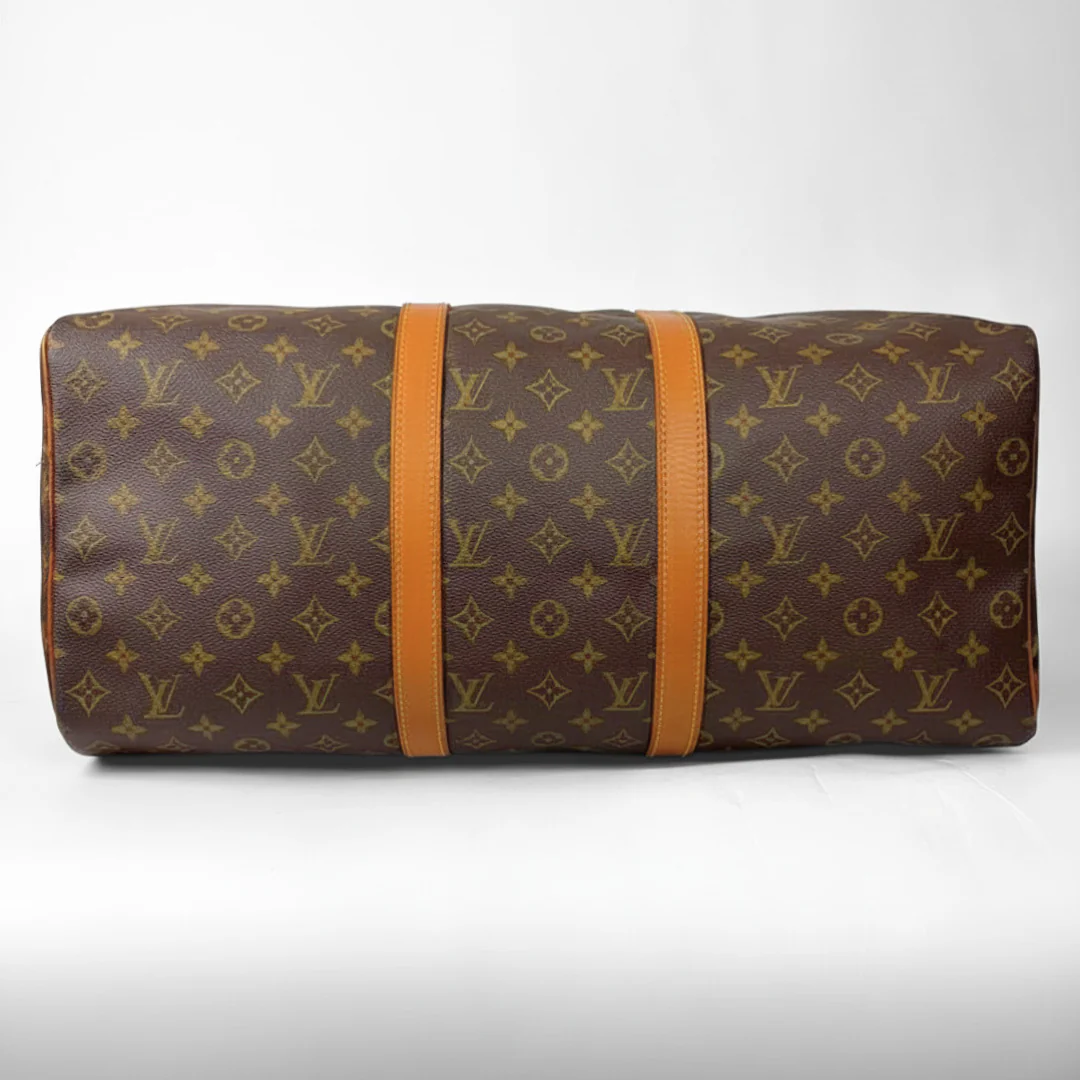 Brown hand bag with orange accents and a prominent logo pattern on a white background