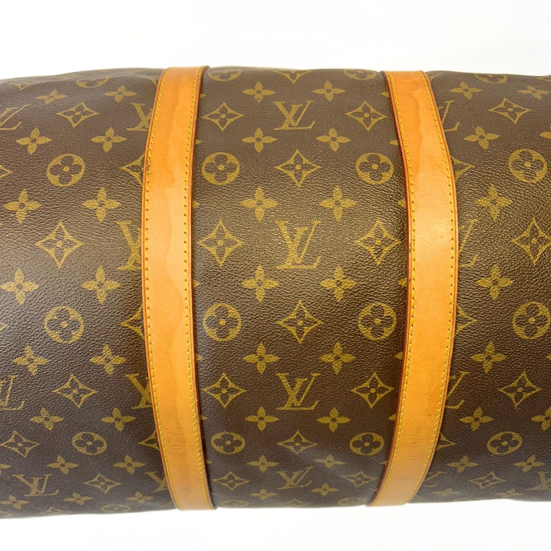Louis Vuitton monogram duffel bag with yellow straps on a white background