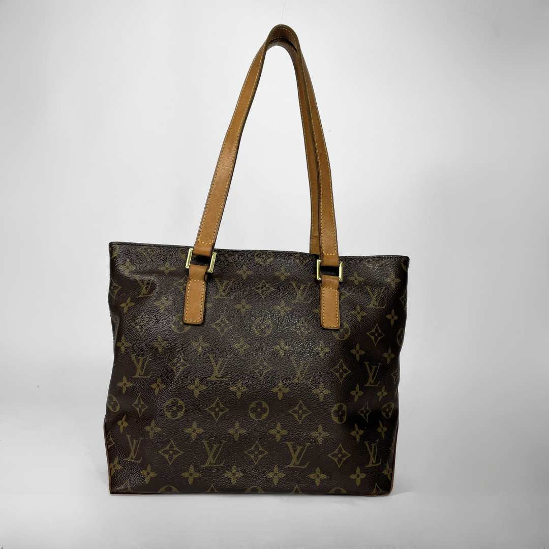 Louis Vuitton monogram canvas tote bag with tan leather shoulder straps and gold-tone hardware, photographed against a light gray studio background.