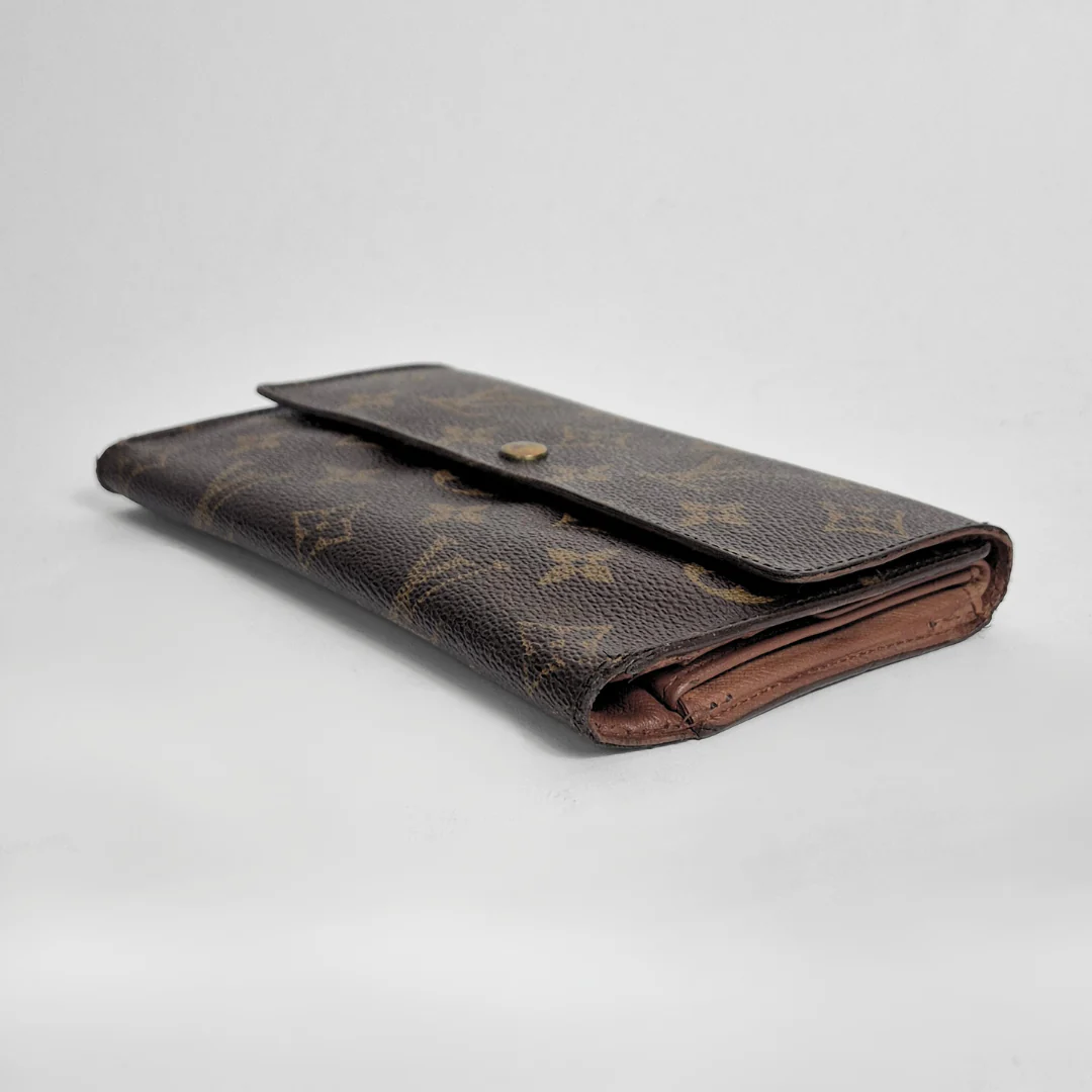 Brown leather wallet with brand logo on a light gray background