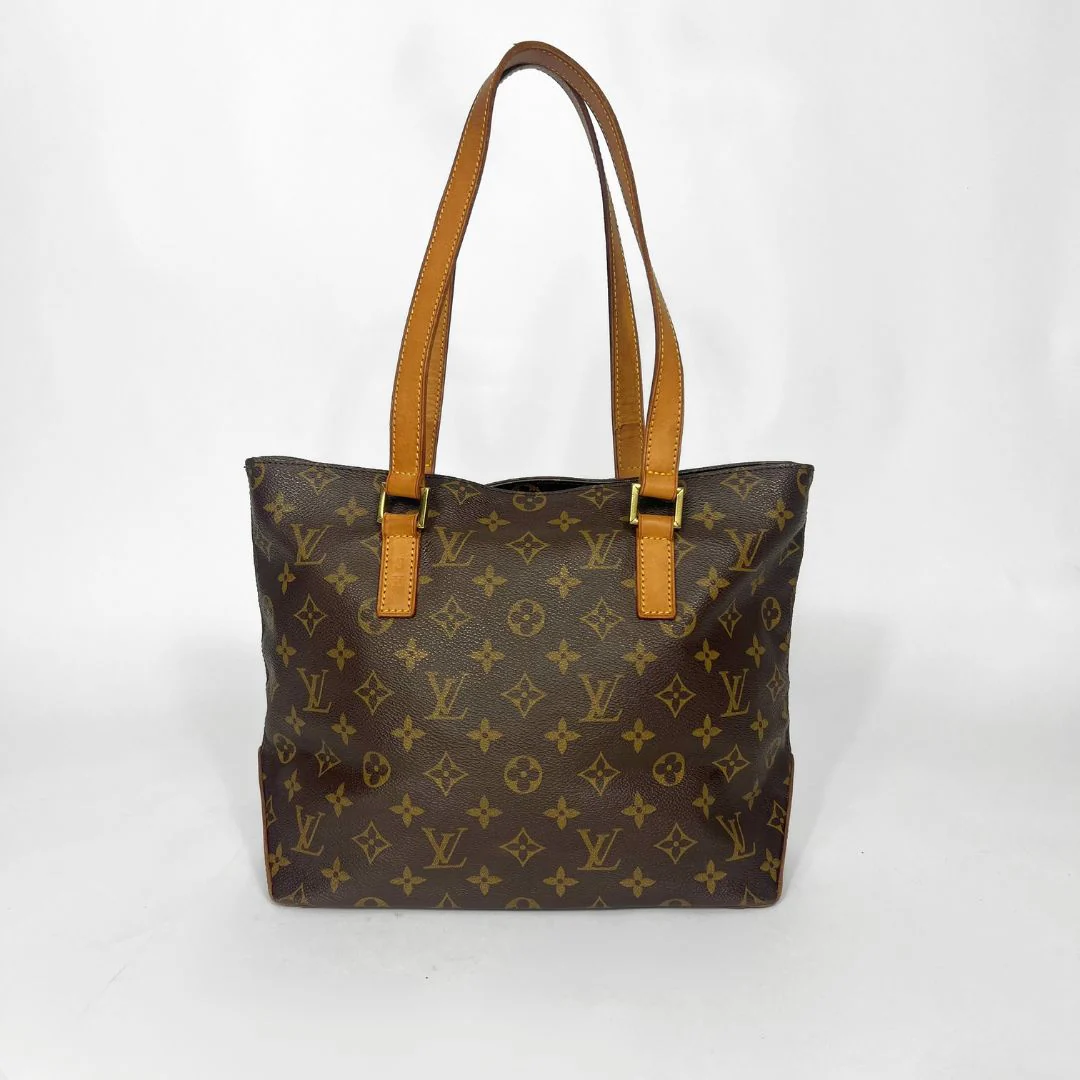 Brown monogram handbag with tan handles on a white background