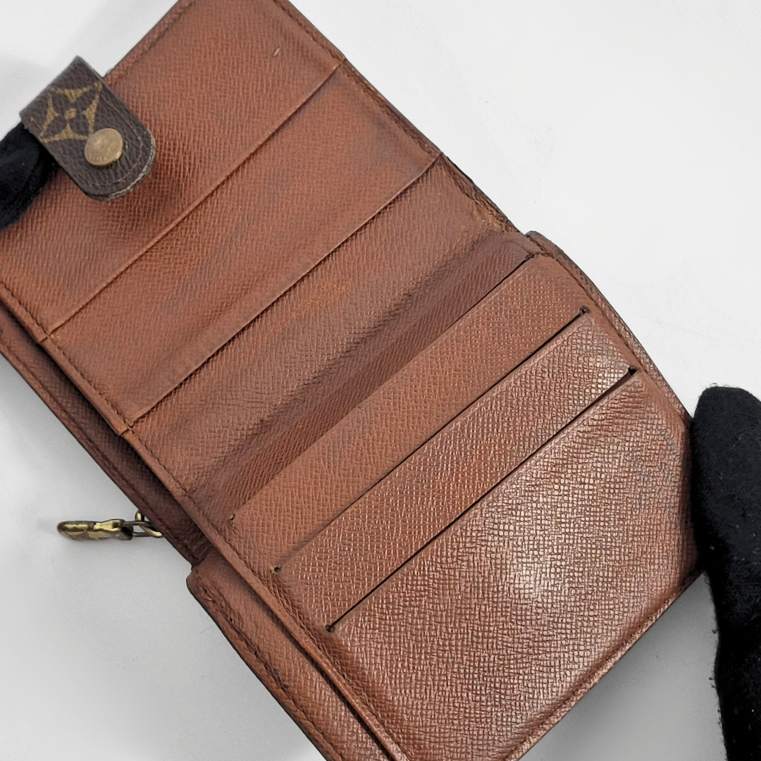 Brown leather wallet with a visible brand logo on a white background