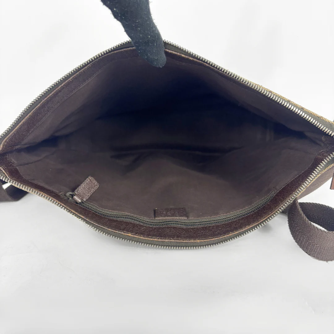 Brown leather bag with a visible brand label on a white background