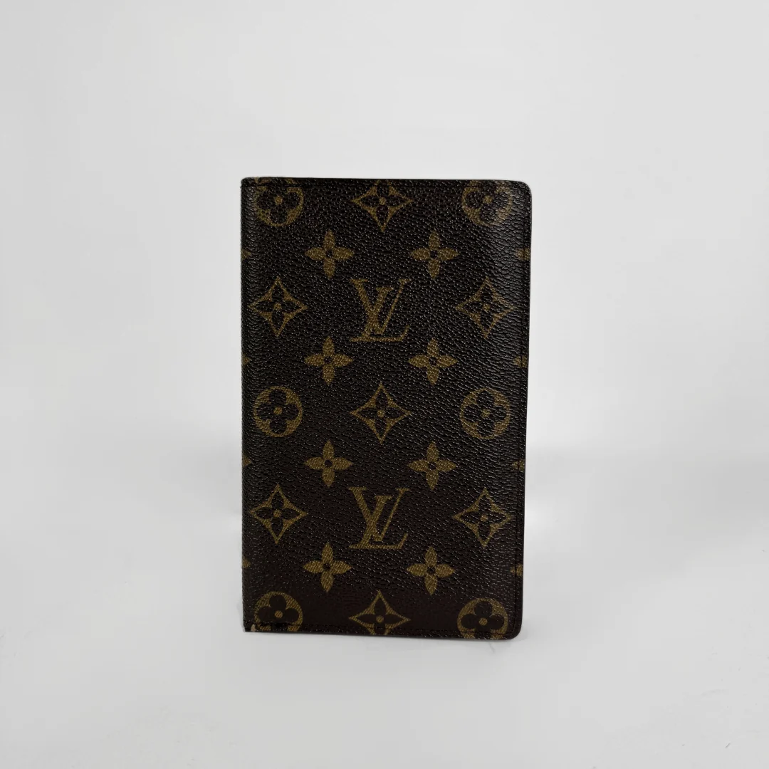 A Louis Vuitton wallet in front a white background