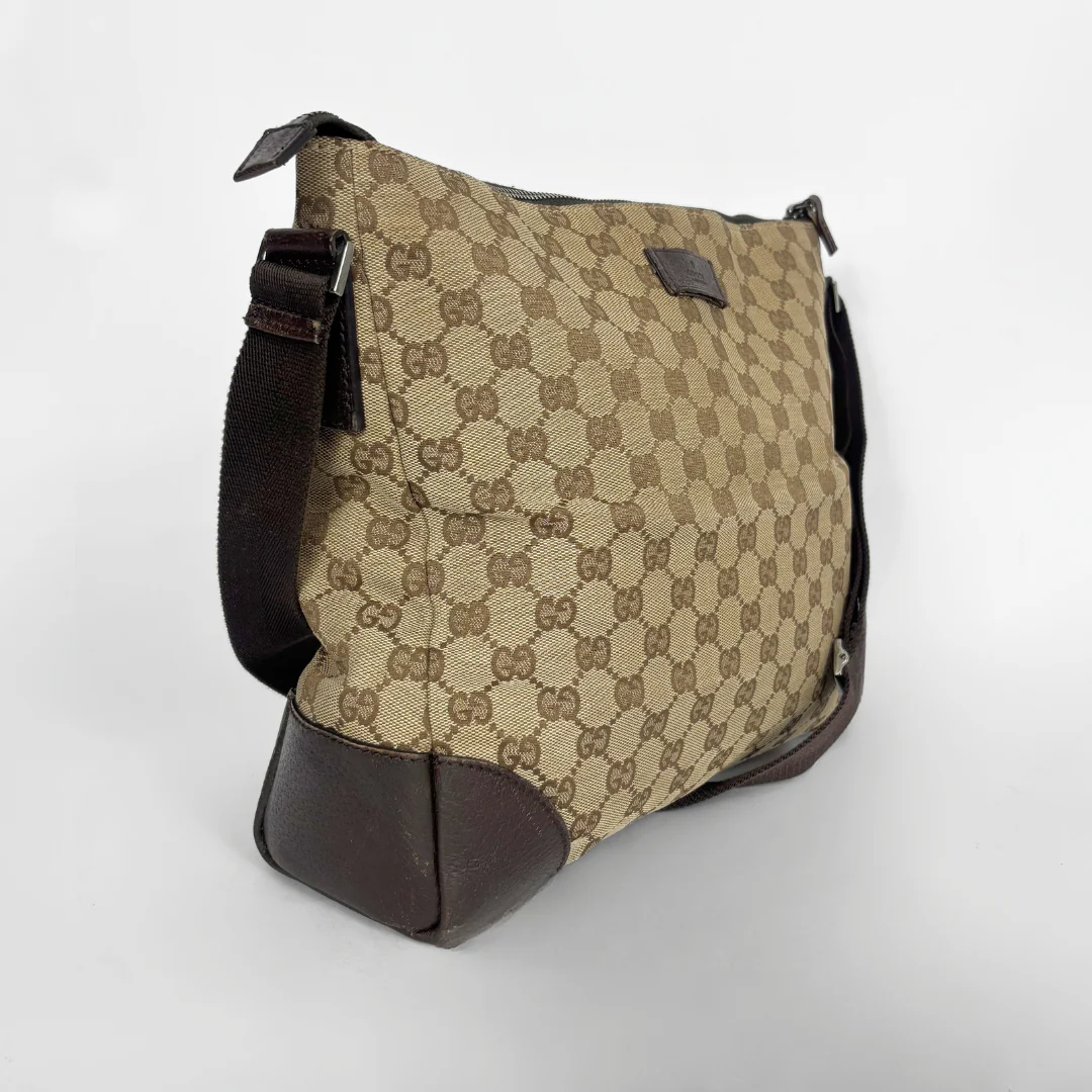 Beige shoulderbag with brown accents and a pattern on a white background
