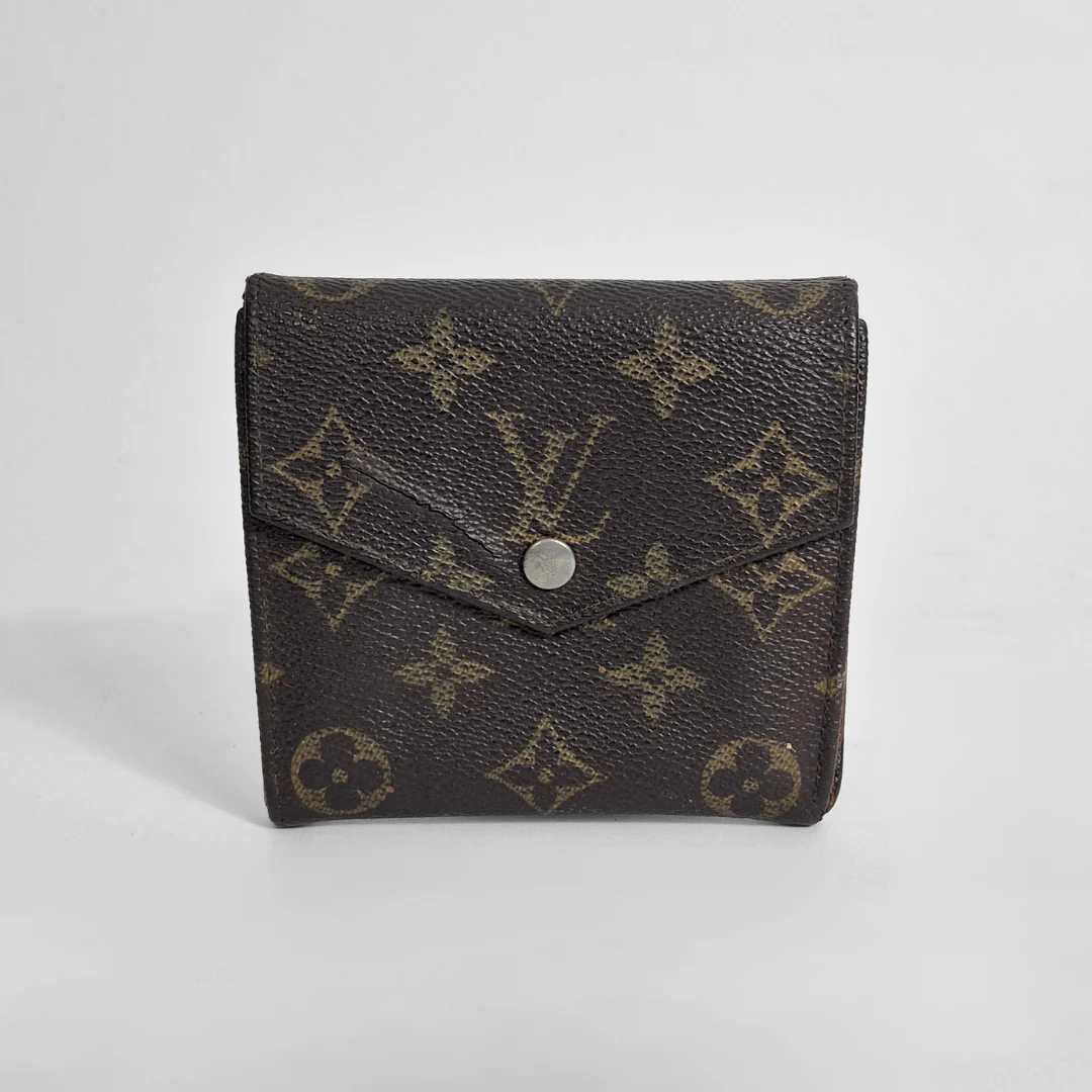 Louis Vuitton wallet with monogram pattern on a white background