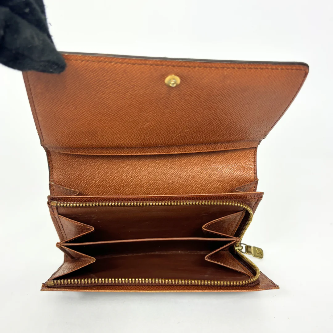 Brown leather wallet with gold zipper on a white background