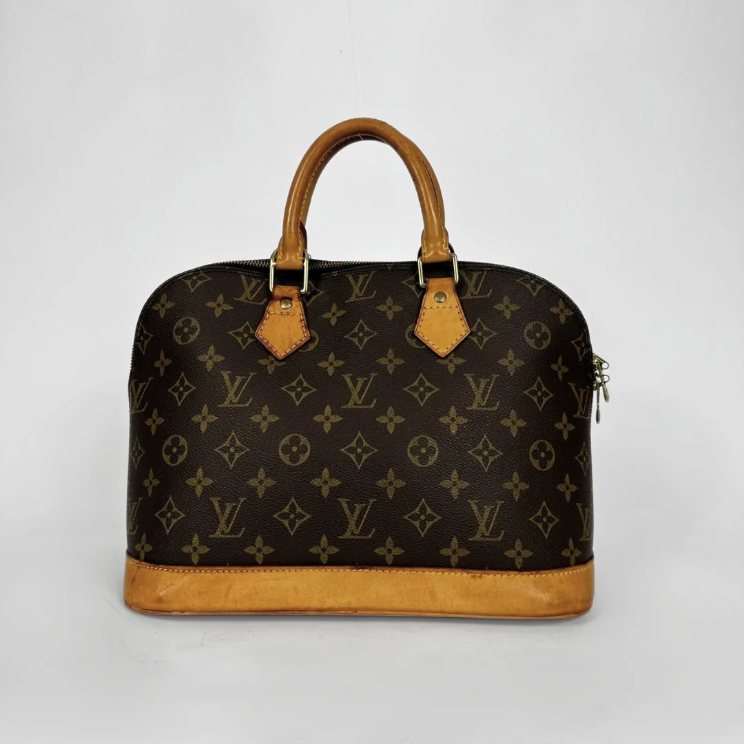 Louis Vuitton monogram canvas dome handbag with tan leather handles and trim, photographed against a light gray studio background.