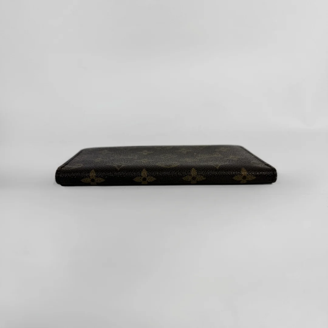 A dark brown Louis Vuitton monogram wallet or card holder shown closed from the front on a plain light gray background.