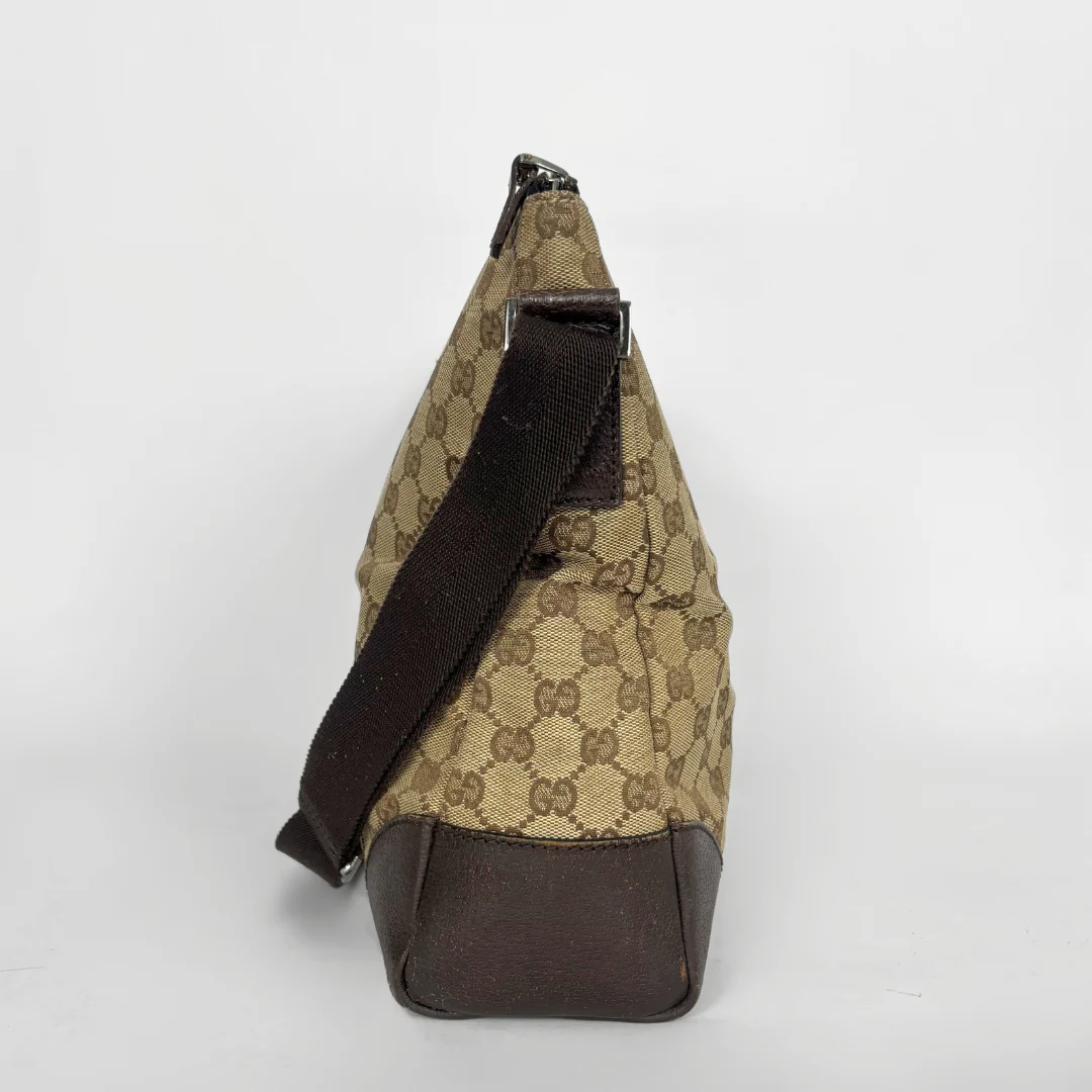 Beige shoulderbag with brown accents and a pattern on a white background