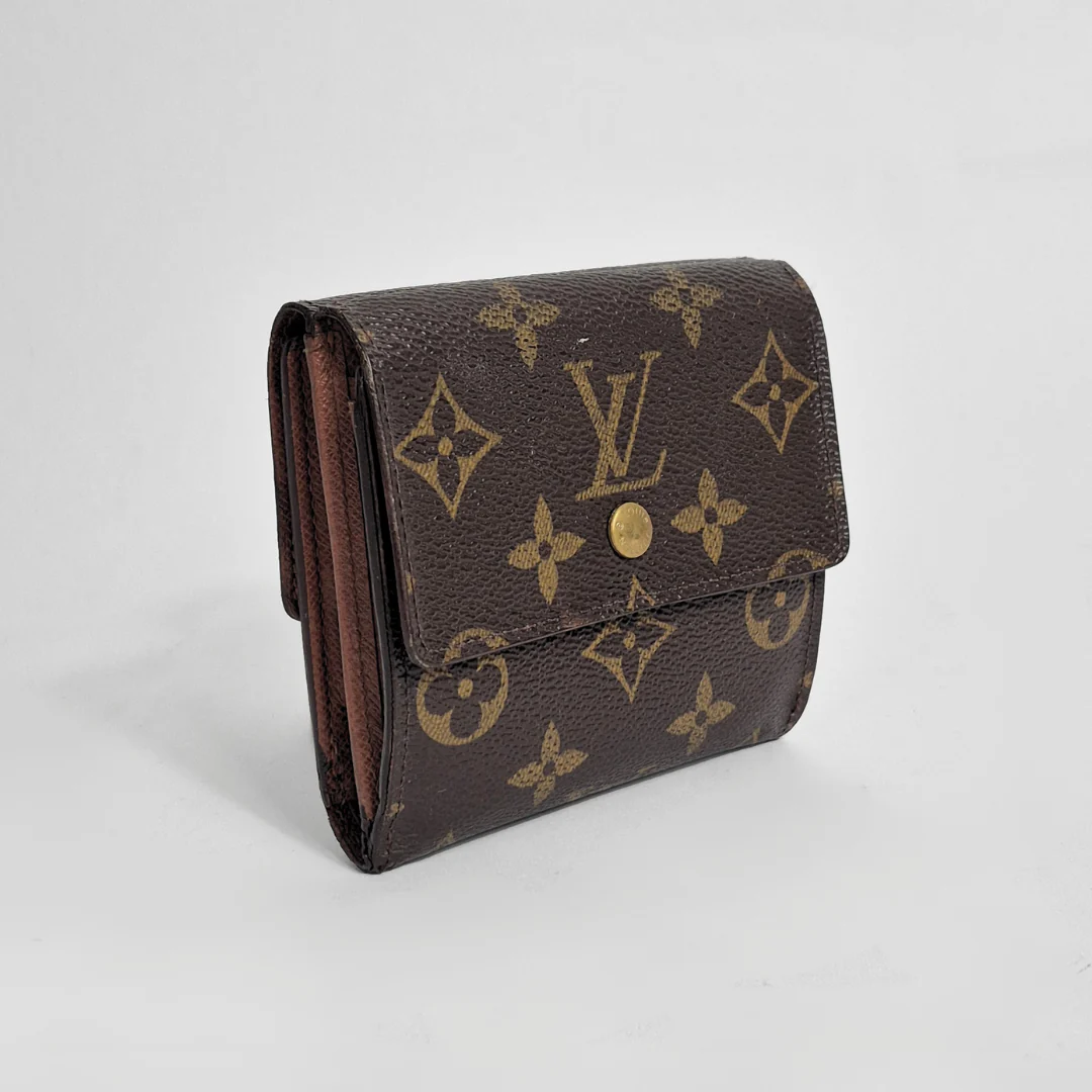 Louis Vuitton wallet with monogram pattern on a light gray background