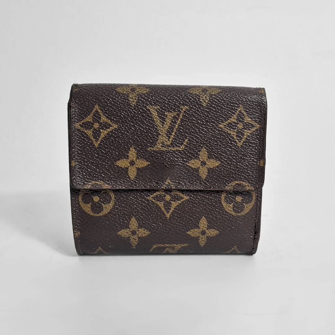 Louis Vuitton wallet with monogram pattern on a light gray background