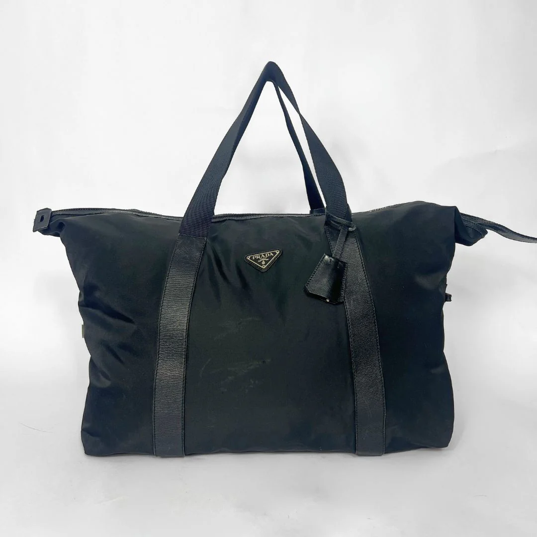 Black duffel bag with Prada logo on a white background