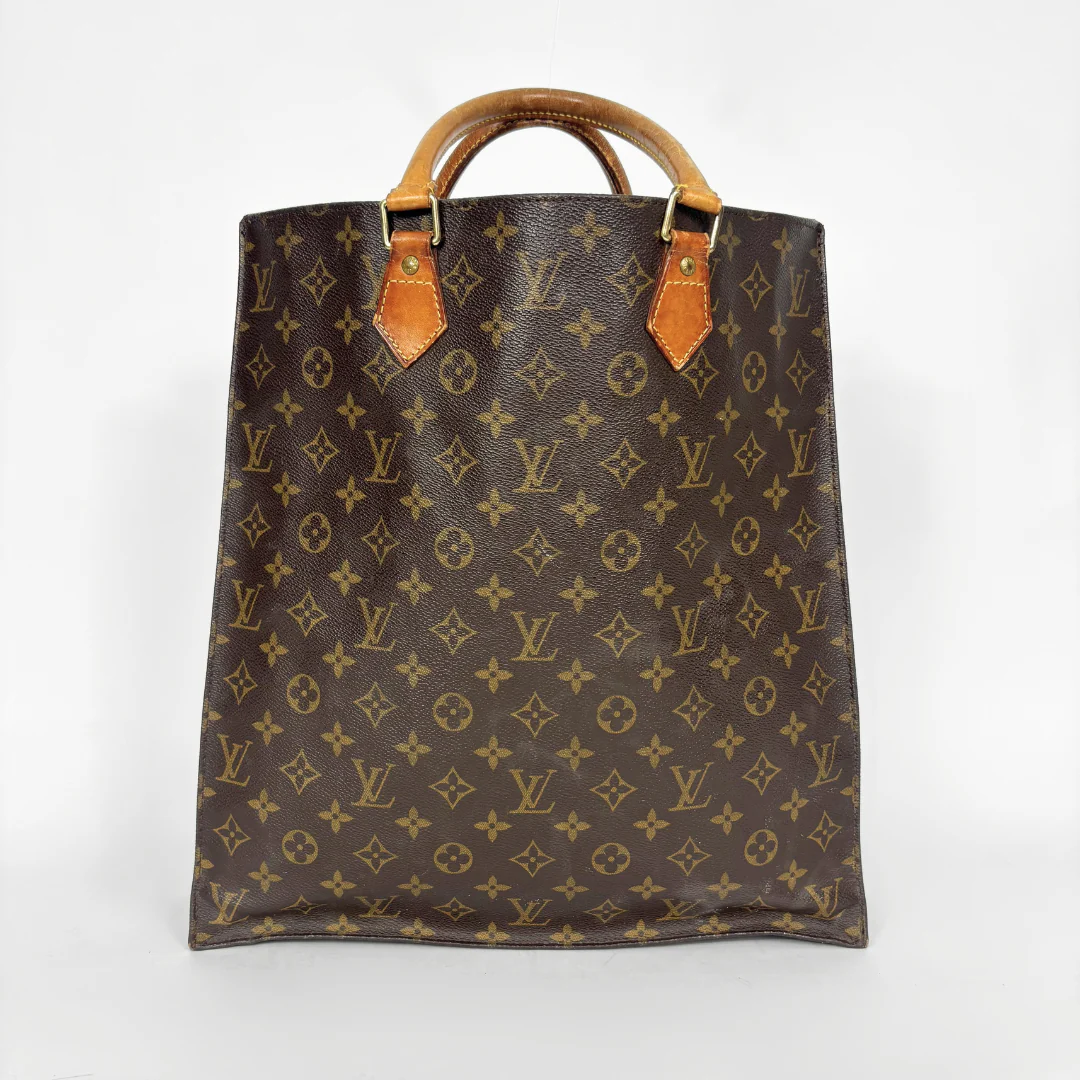 Brown leather bag with monogram pattern on a white background