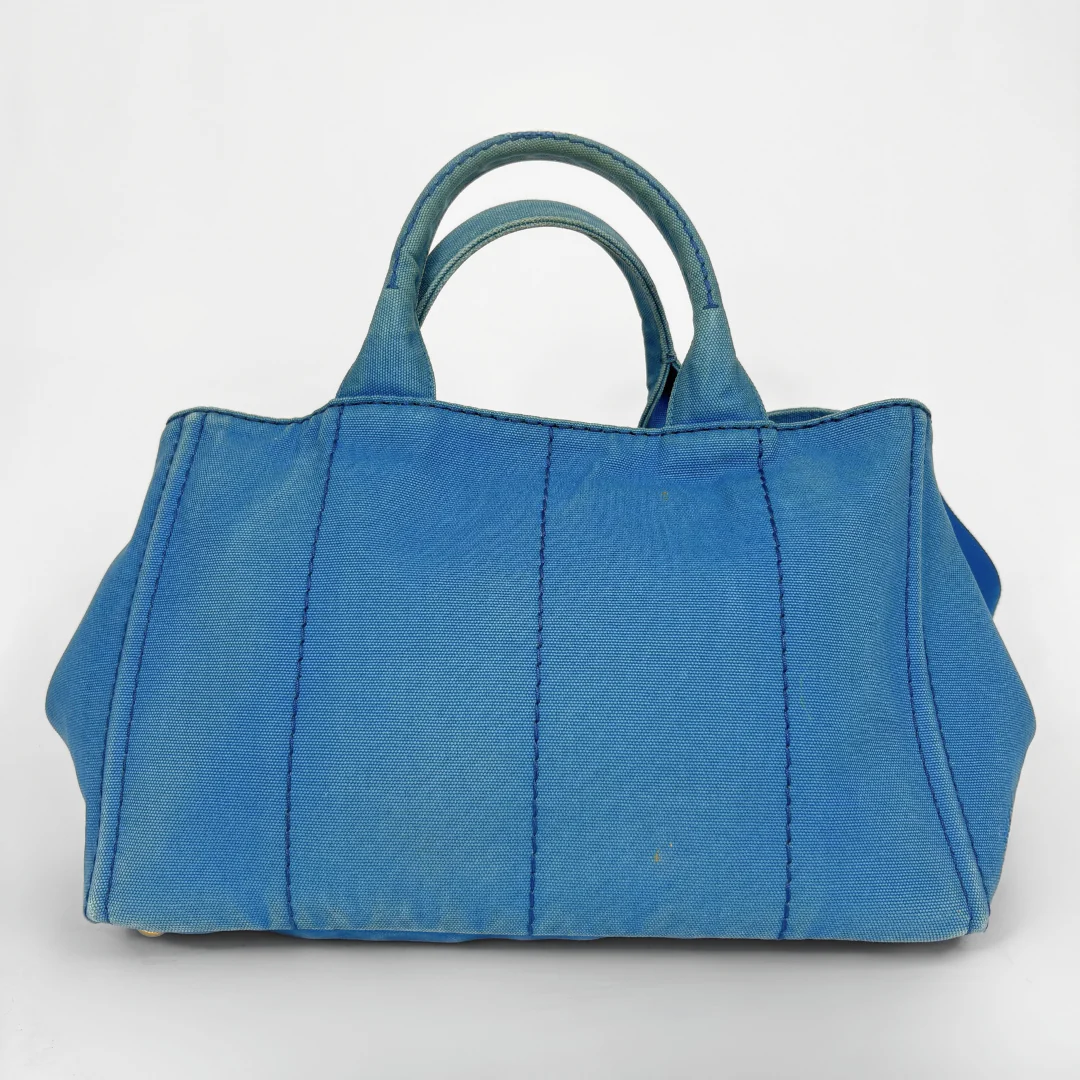 Blue Prada handbag on a white background