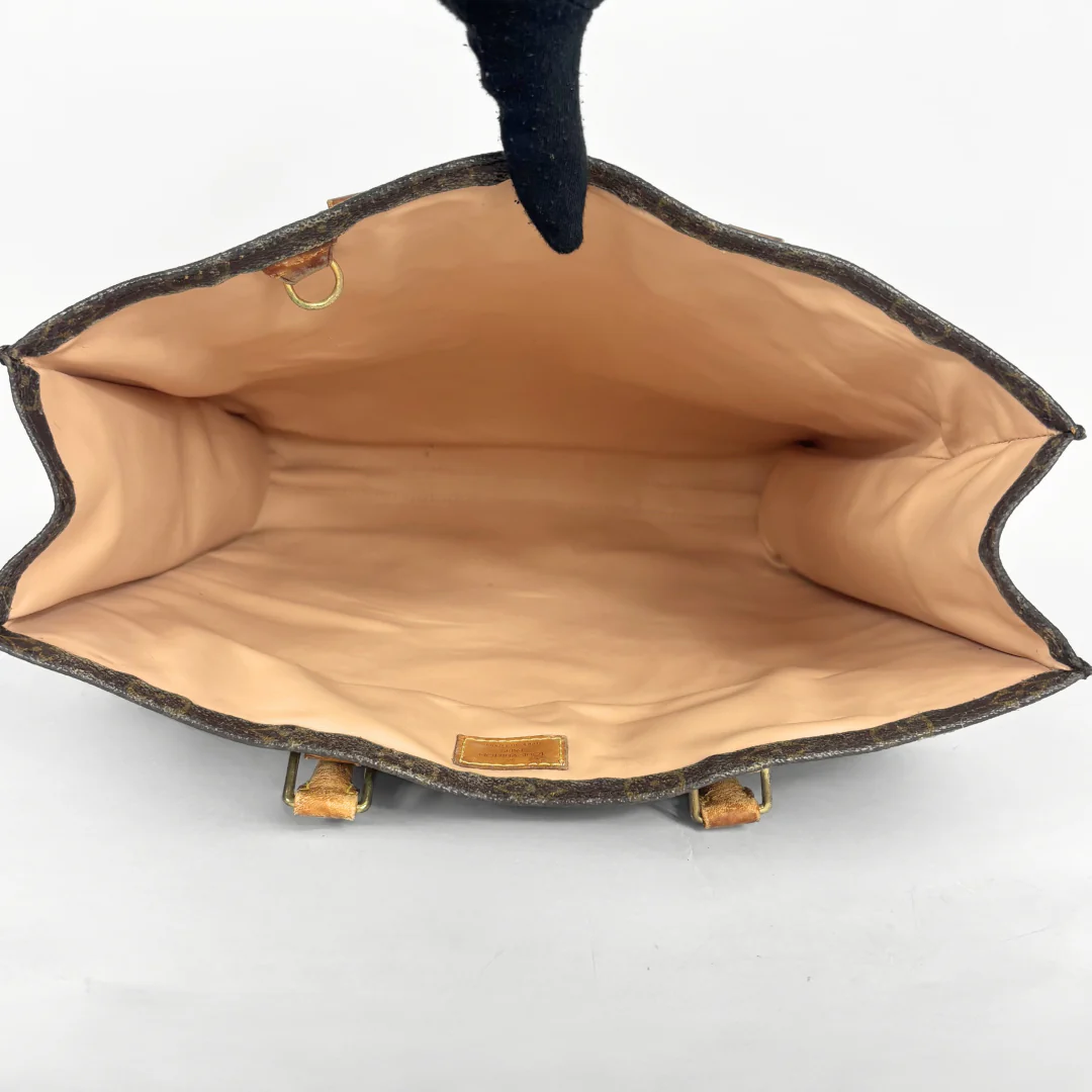Open handbag showing interior with visible brand label on a white background