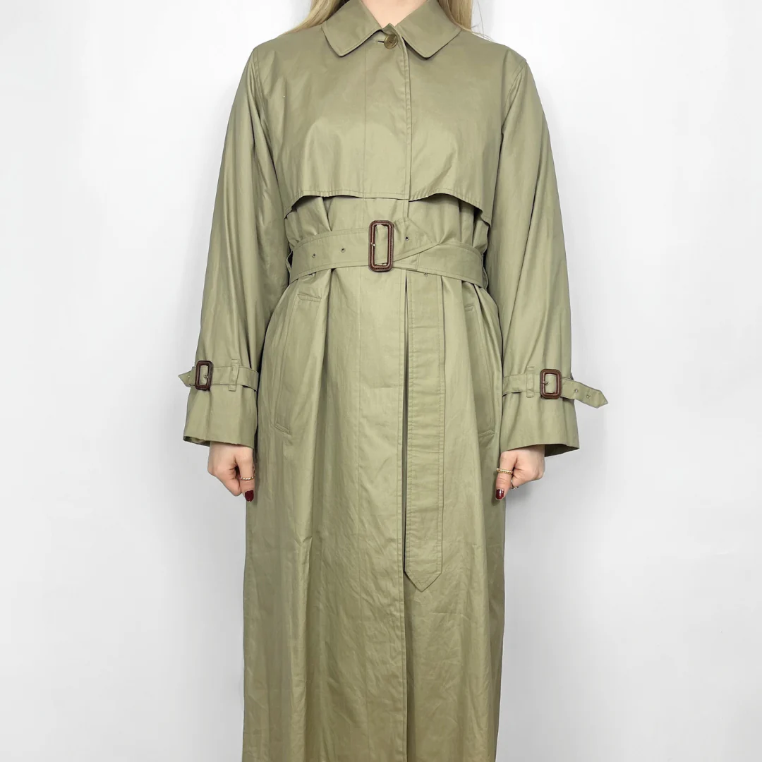 Green trench coat with belt on a white background