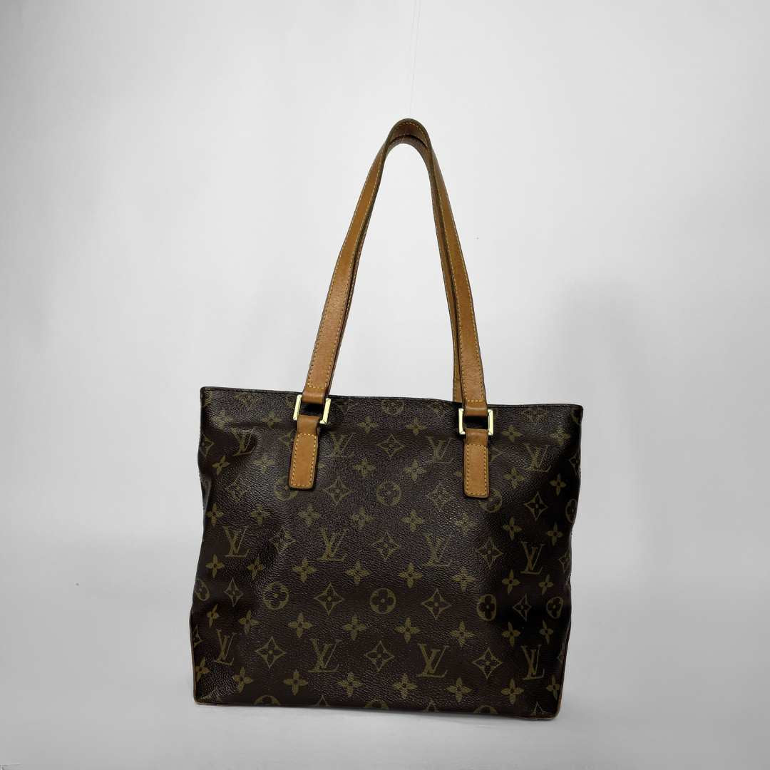 Louis Vuitton monogram canvas tote bag with tan leather shoulder straps and gold-tone hardware, photographed against a plain light gray background.