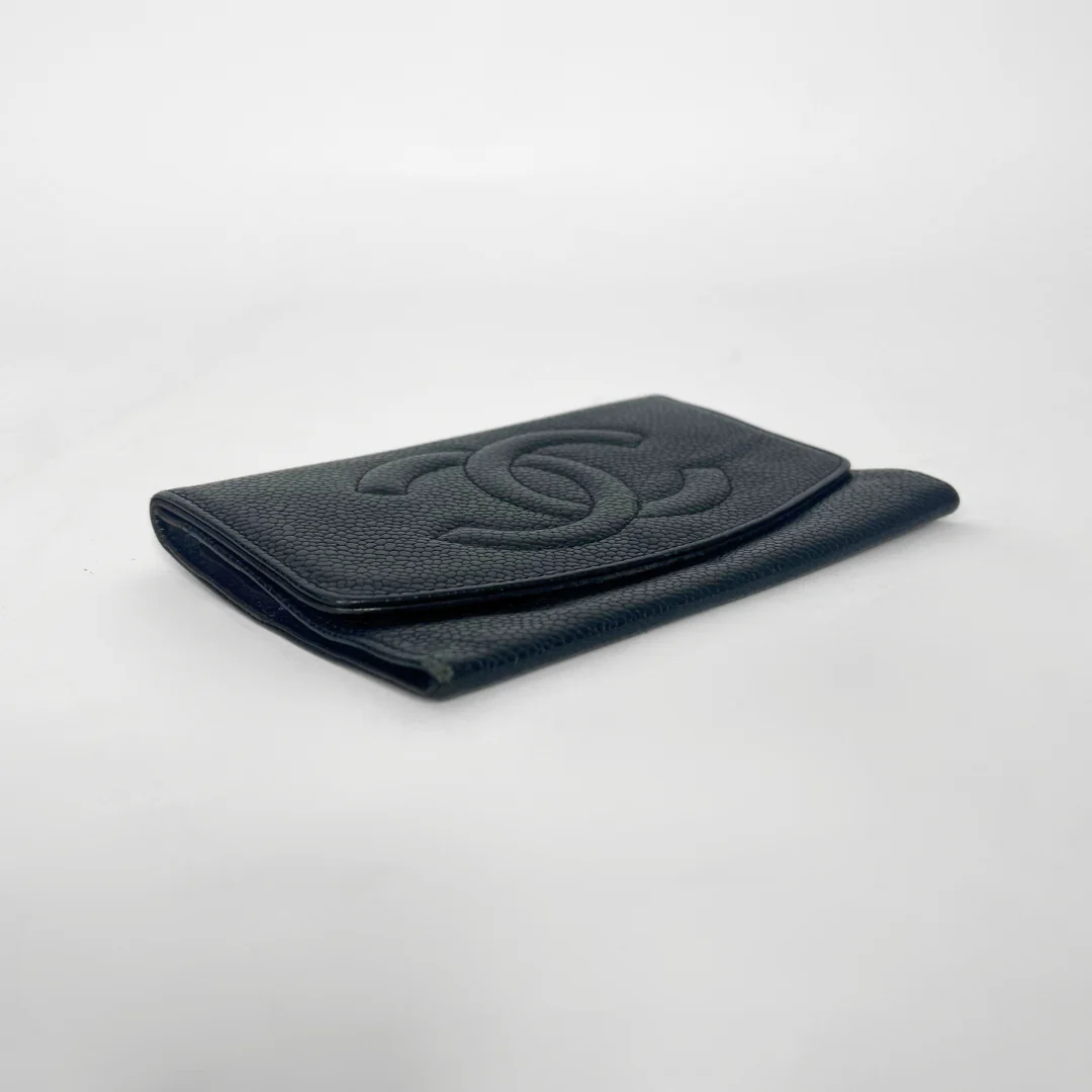 Black textured wallet on a light gray background