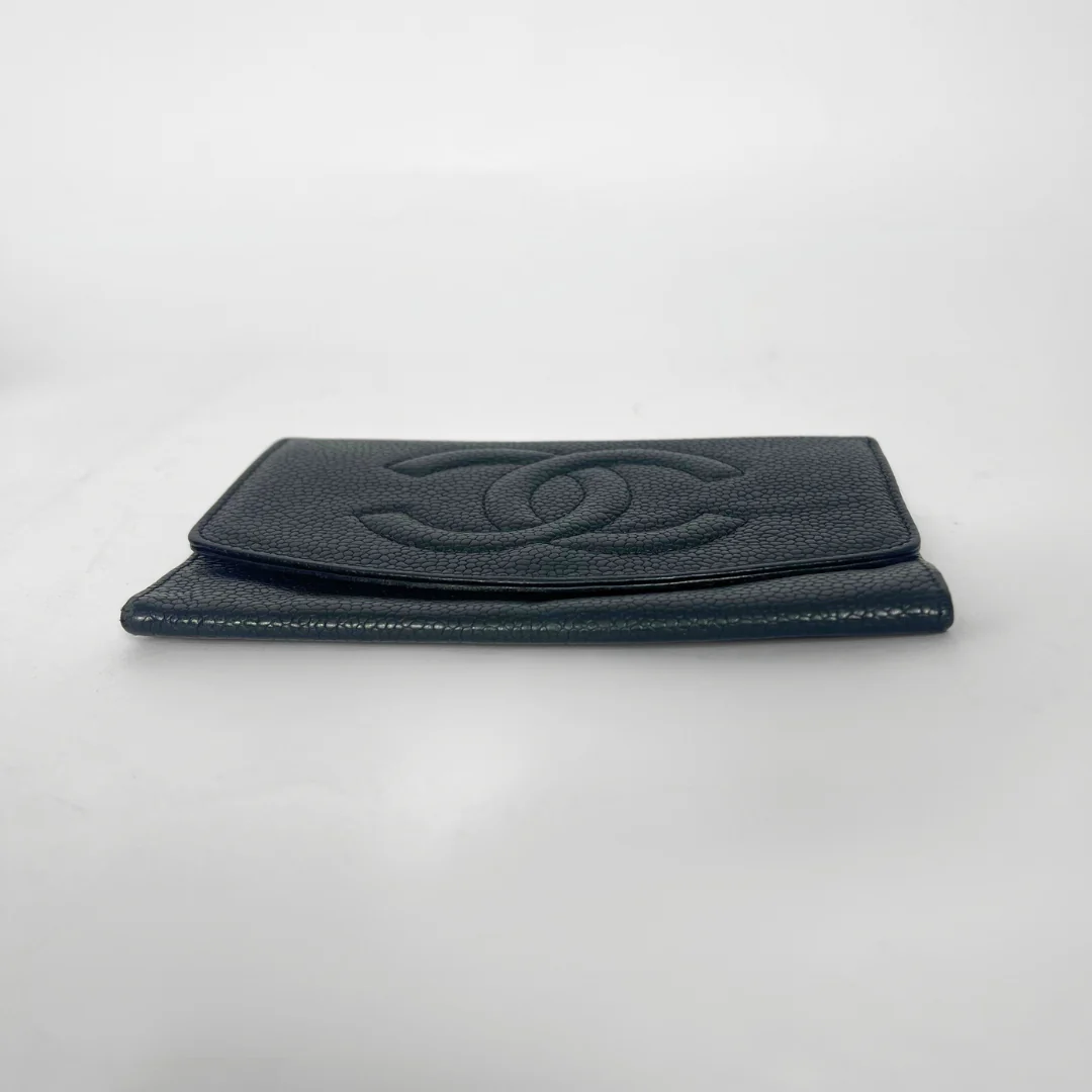 Black leather wallet with Chanel logo on a light gray background