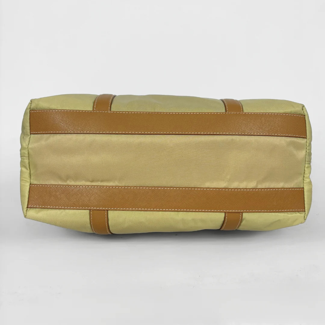 Prada yellow nylon tote bag with tan leather handles and triangle logo.