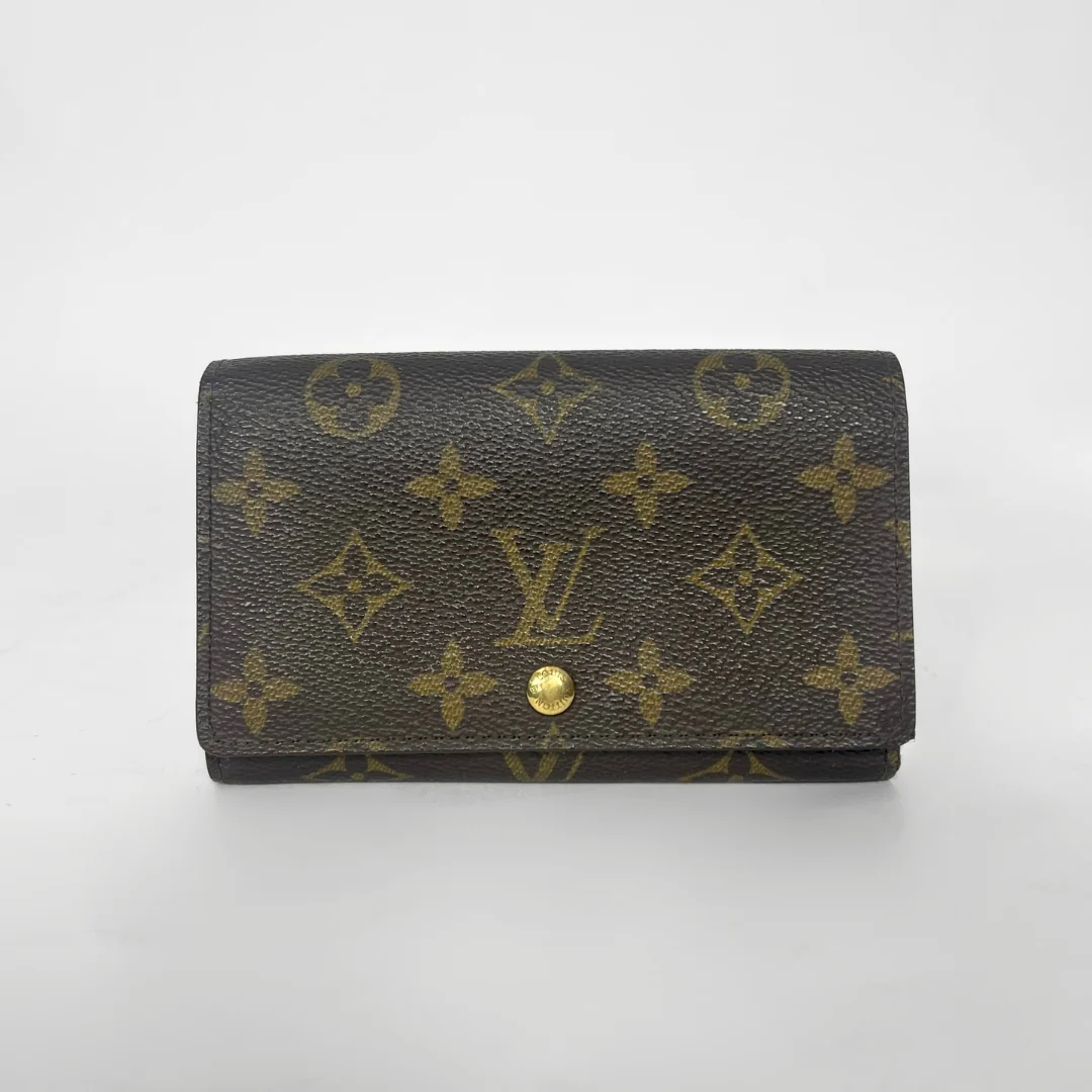 Louis Vuitton wallet with monogram pattern on a white background