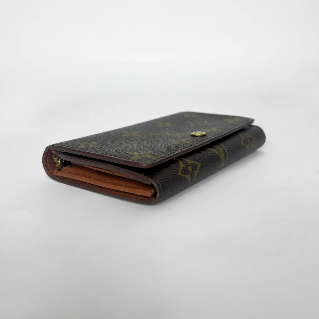 Folded wallet with brown leather interior on a white background