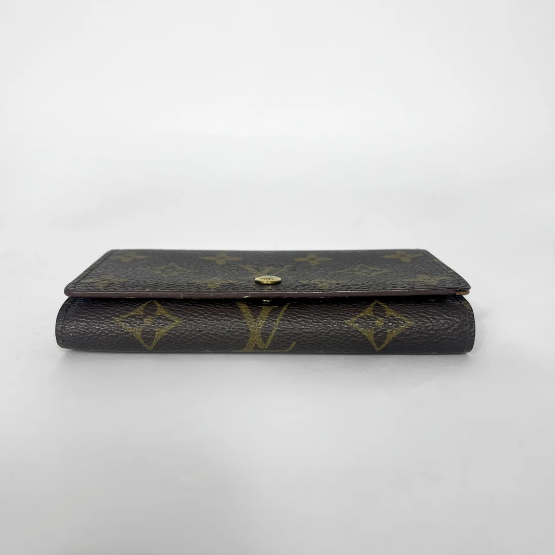 Louis Vuitton wallet with monogram pattern on a white background