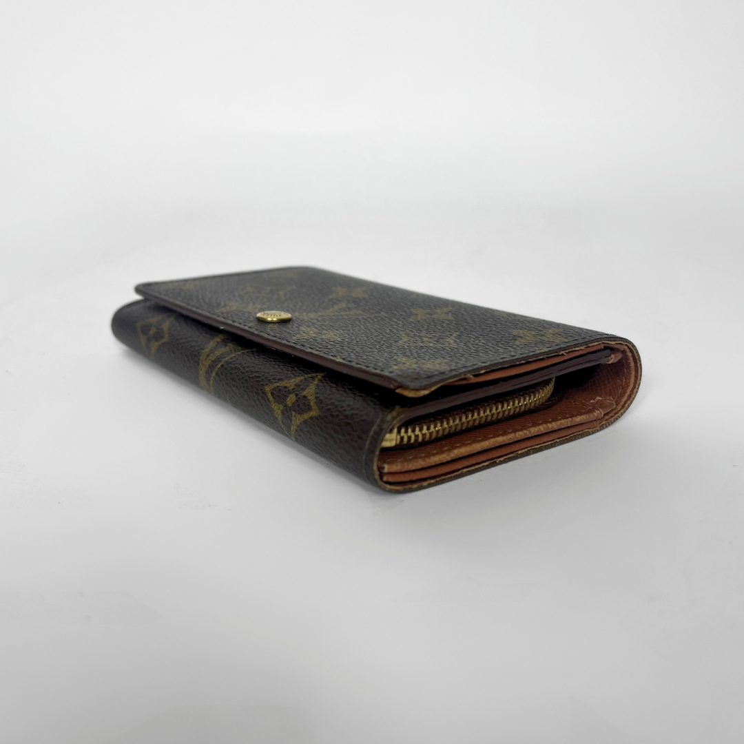 Folded wallet with brown leather interior on a white background
