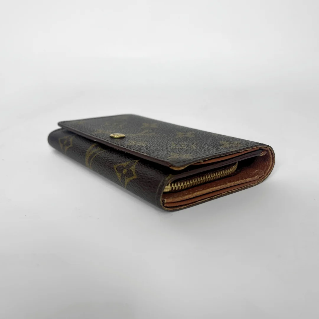 Louis Vuitton wallet with monogram pattern on a white background
