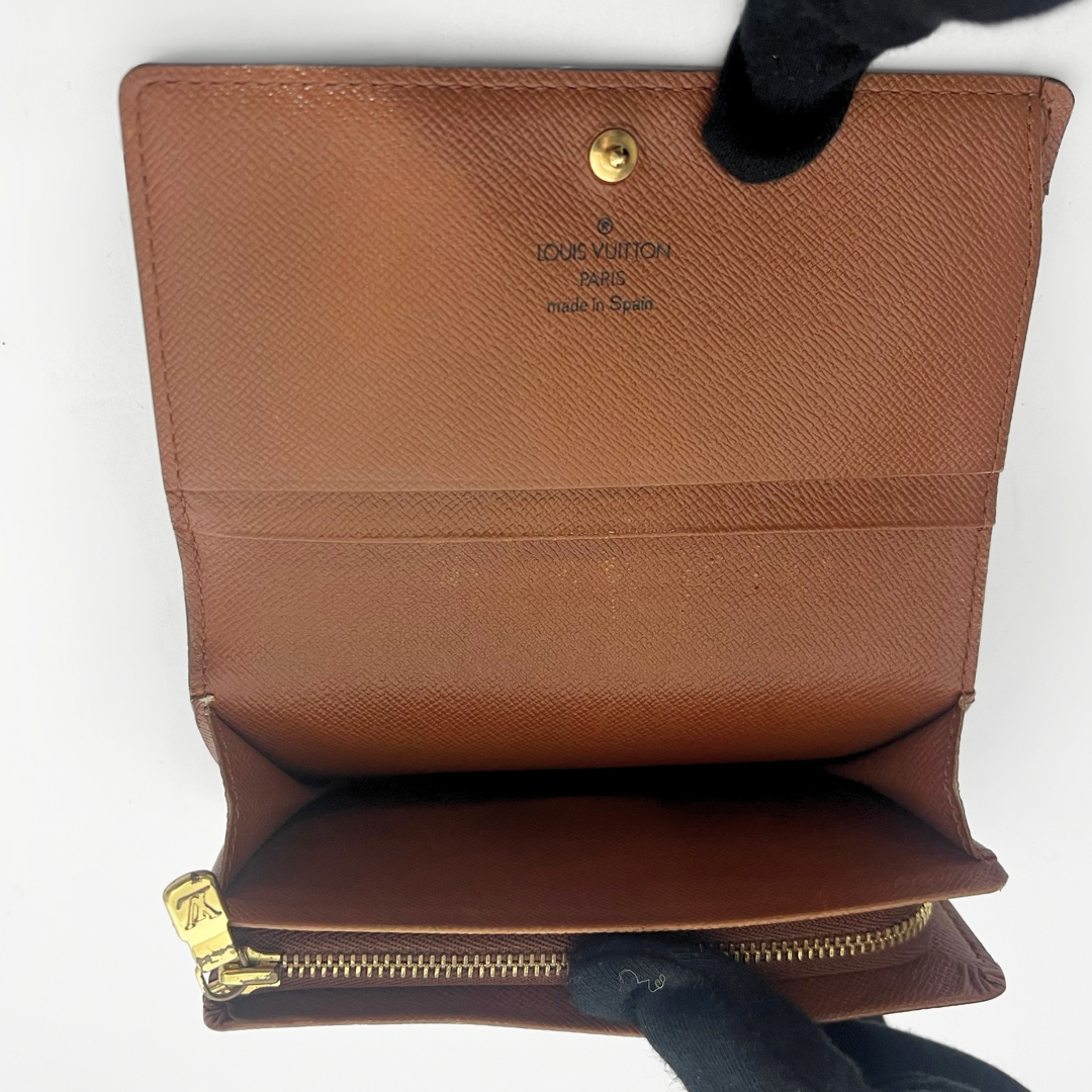 Folded wallet with brown leather interior on a white background