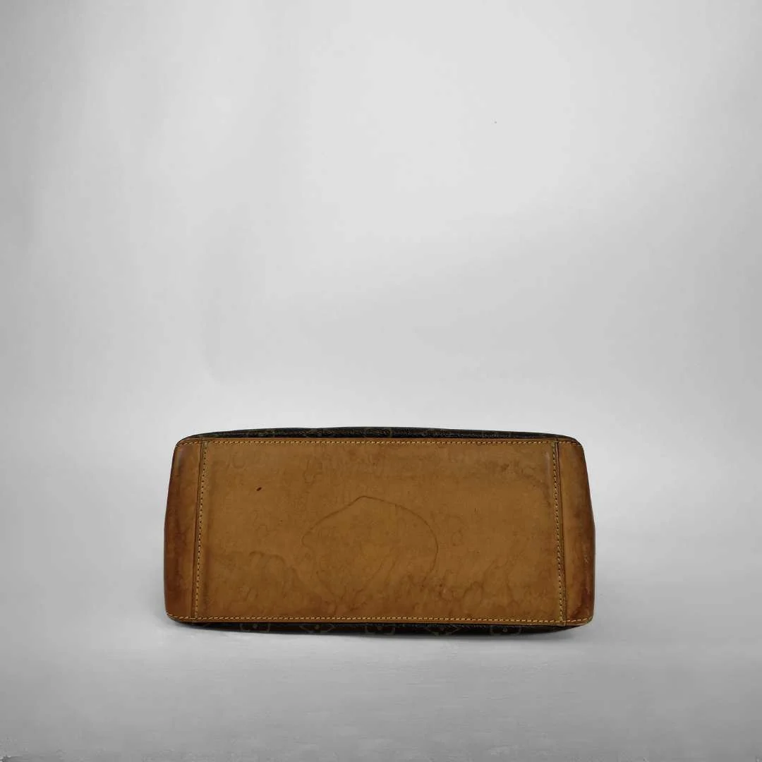 A tan leather clutch or wallet with a distressed, worn finish and visible scuffs, photographed against a neutral light gray background.