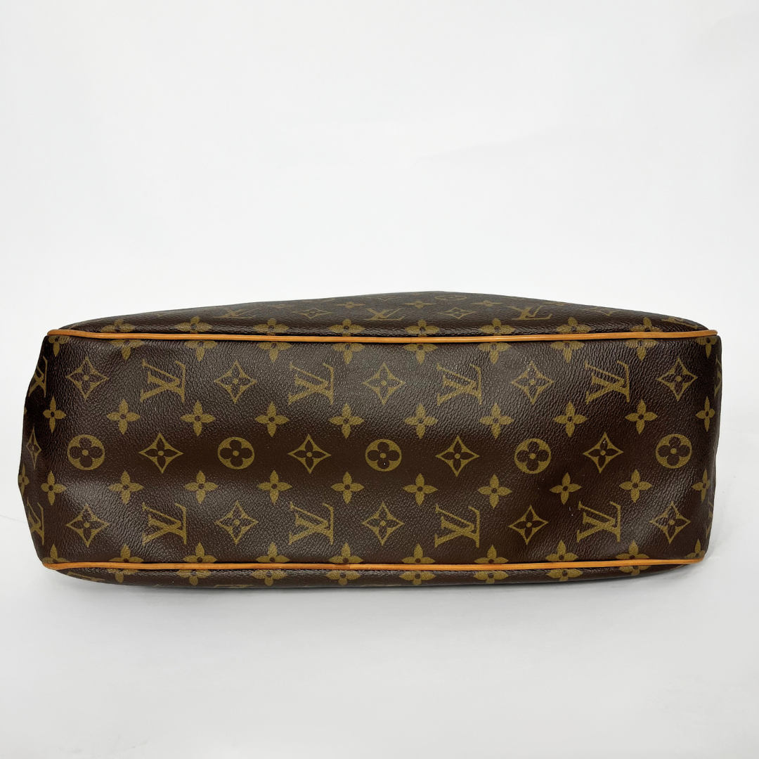 Brown handbag with gold monogram pattern on a white background