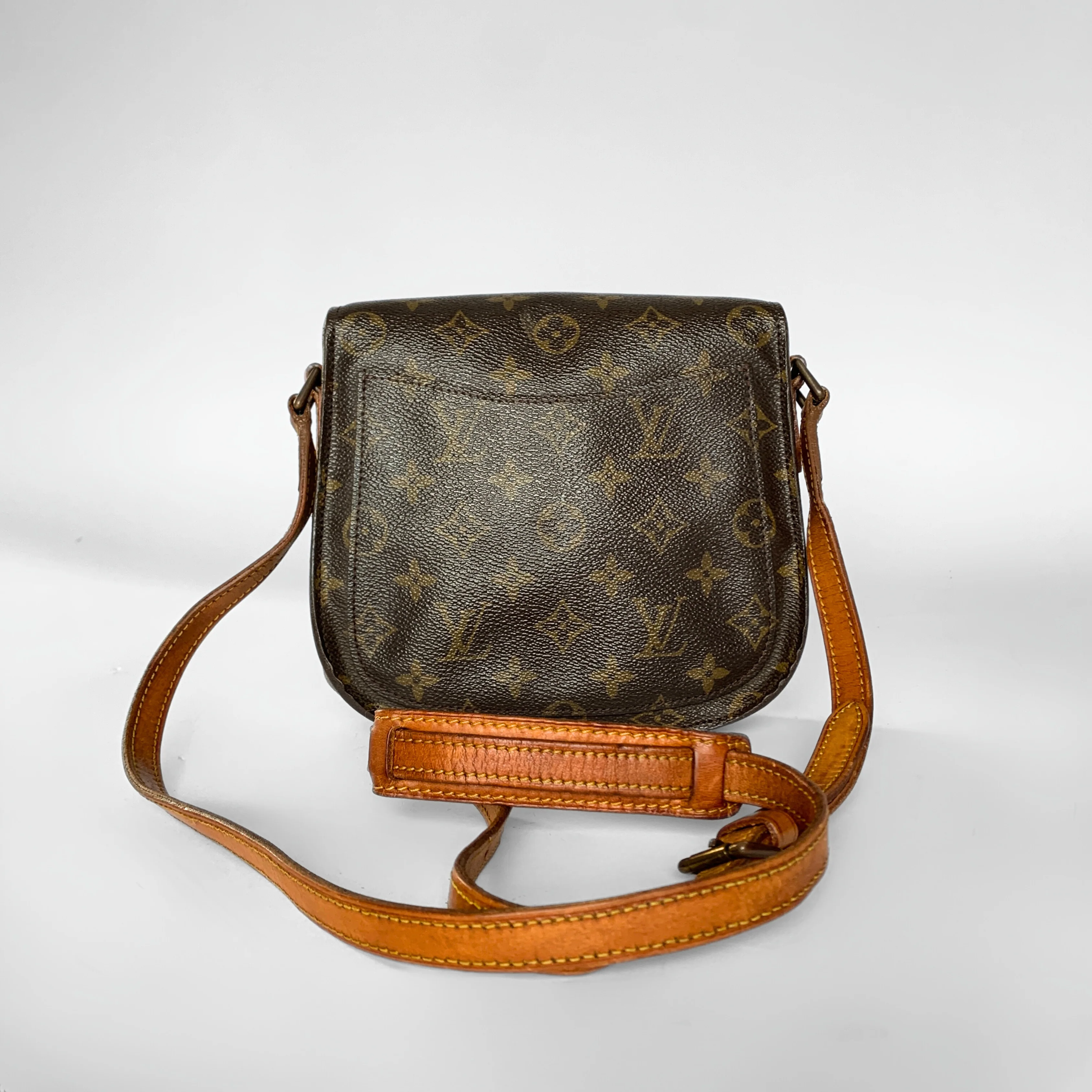 Brown leather handbag with monogram pattern on a white background