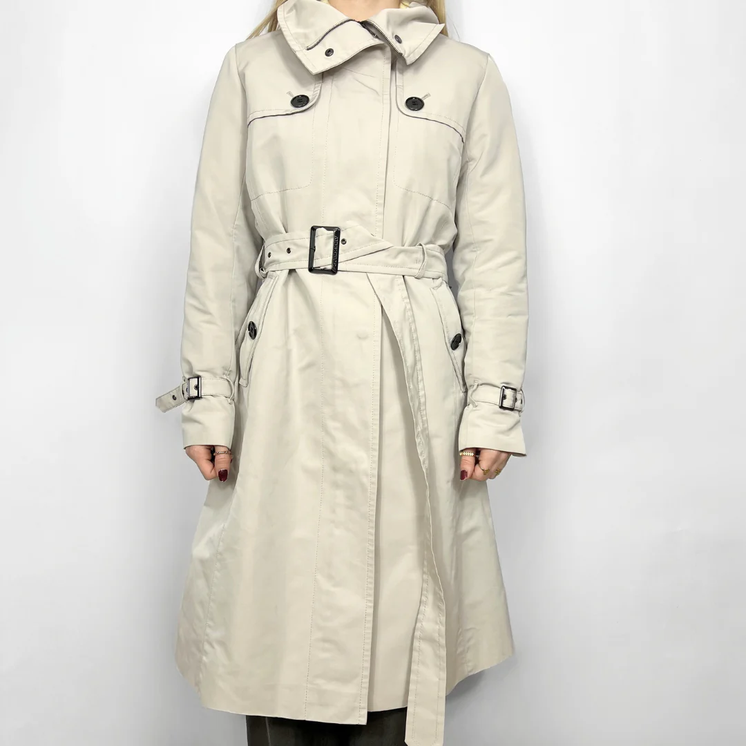 Beige trench coat with a belt on a white background