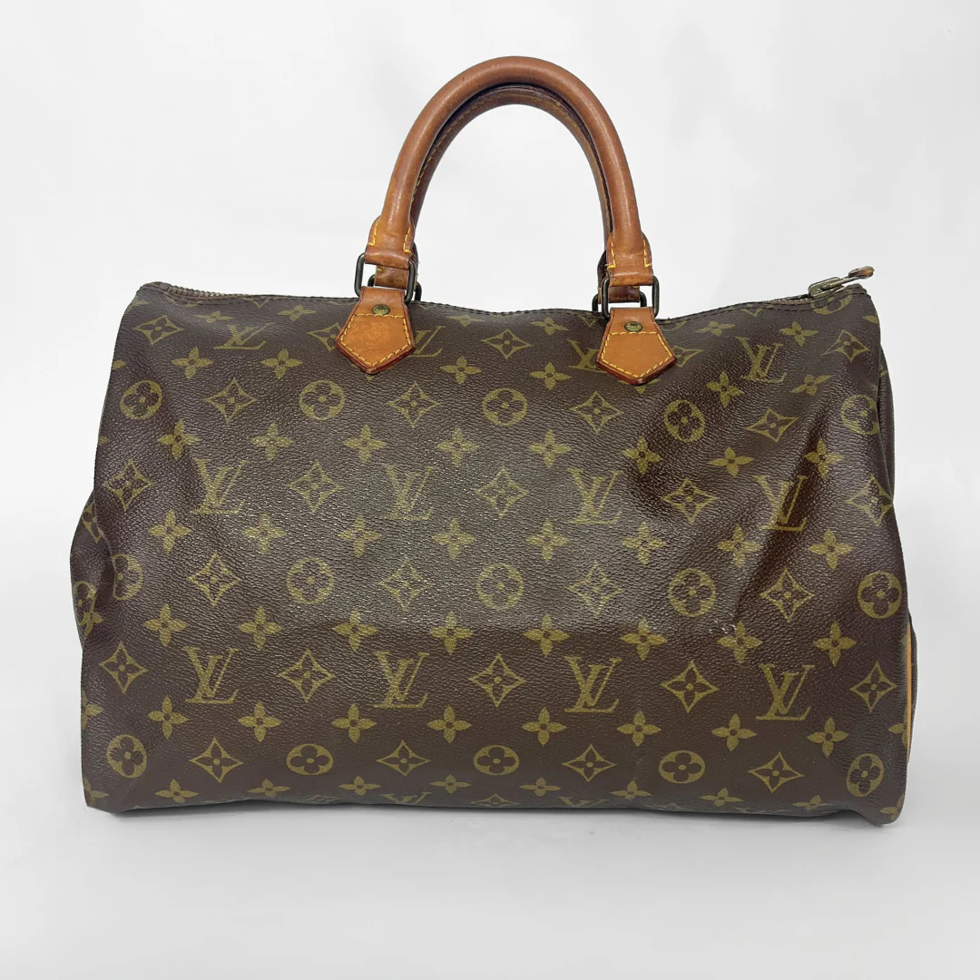 Brown handbag with monogram pattern on a white background