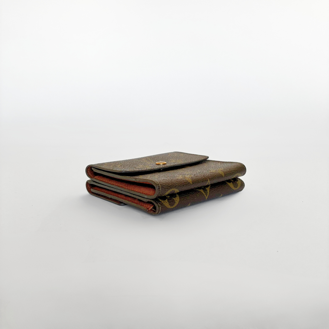 Louis Vuitton wallet with monogram pattern on a white background