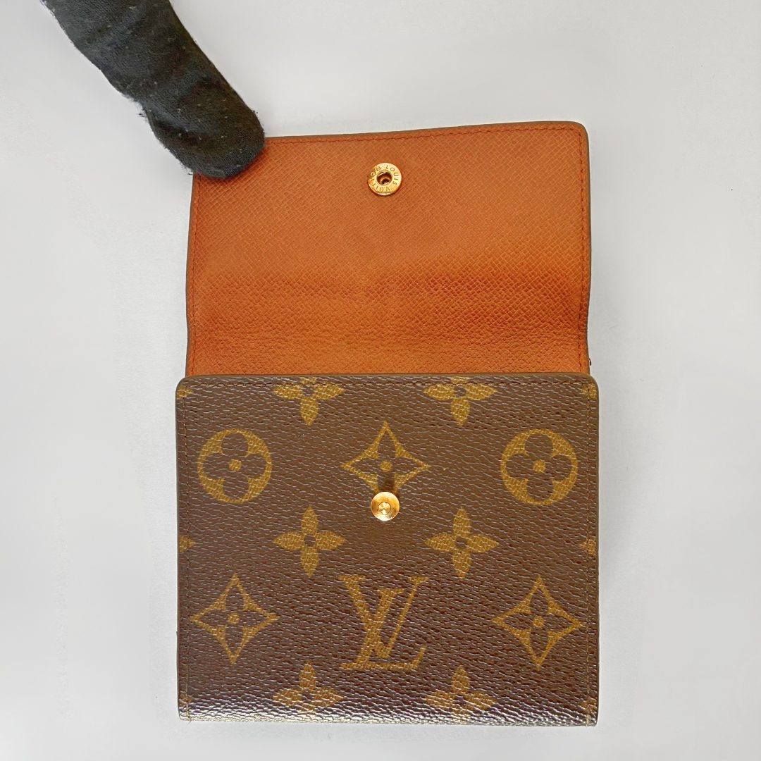 Louis Vuitton wallet with monogram pattern on a white background