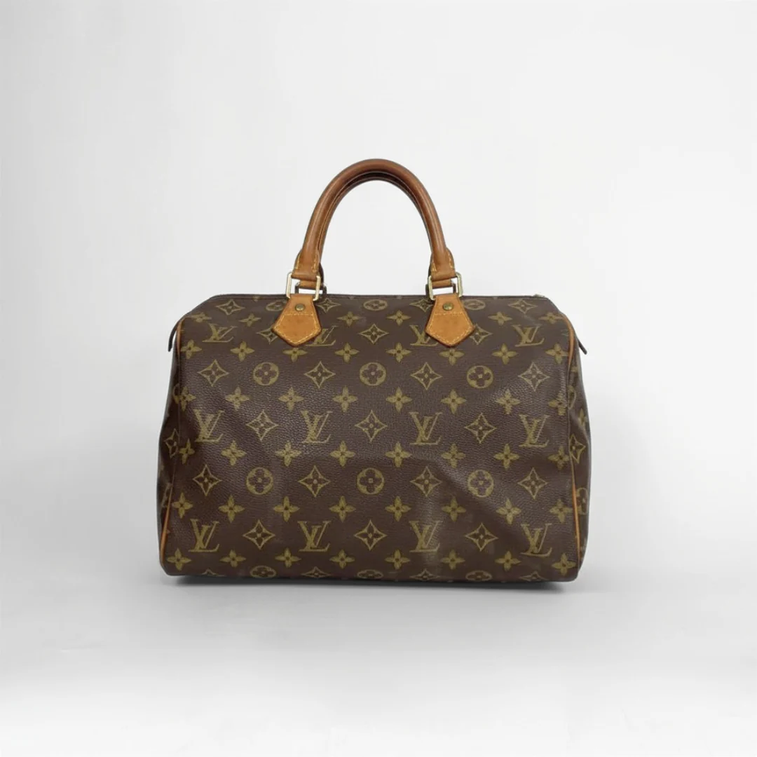 A classic Louis Vuitton monogram canvas duffel bag with tan leather handles and gold-tone hardware, photographed against a neutral light gray background.