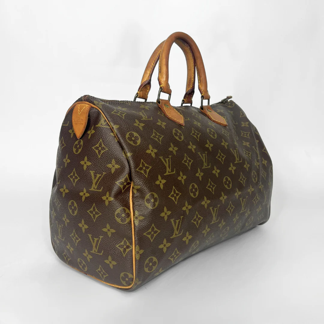 Brown leather handbag with visible brand logo on a white background