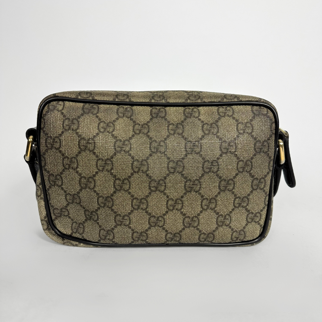 Gucci handbag with monogram pattern on a white background