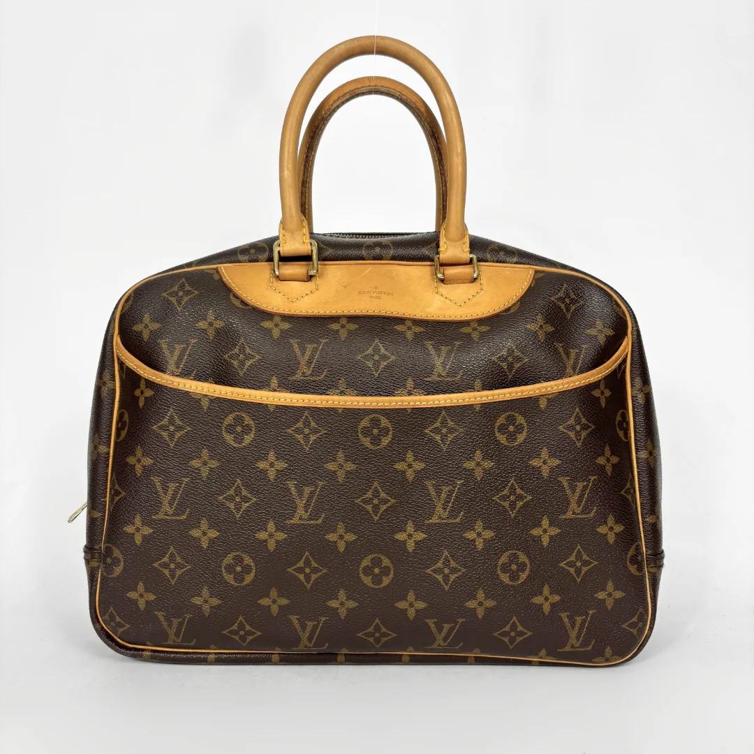 Designer handbag with monogram pattern on a white background