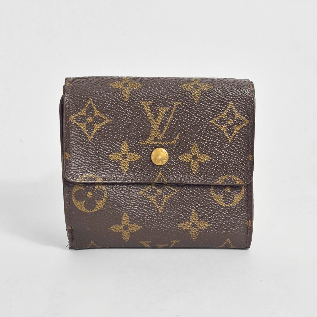 Brown wallet with gold monogram pattern on a light gray background