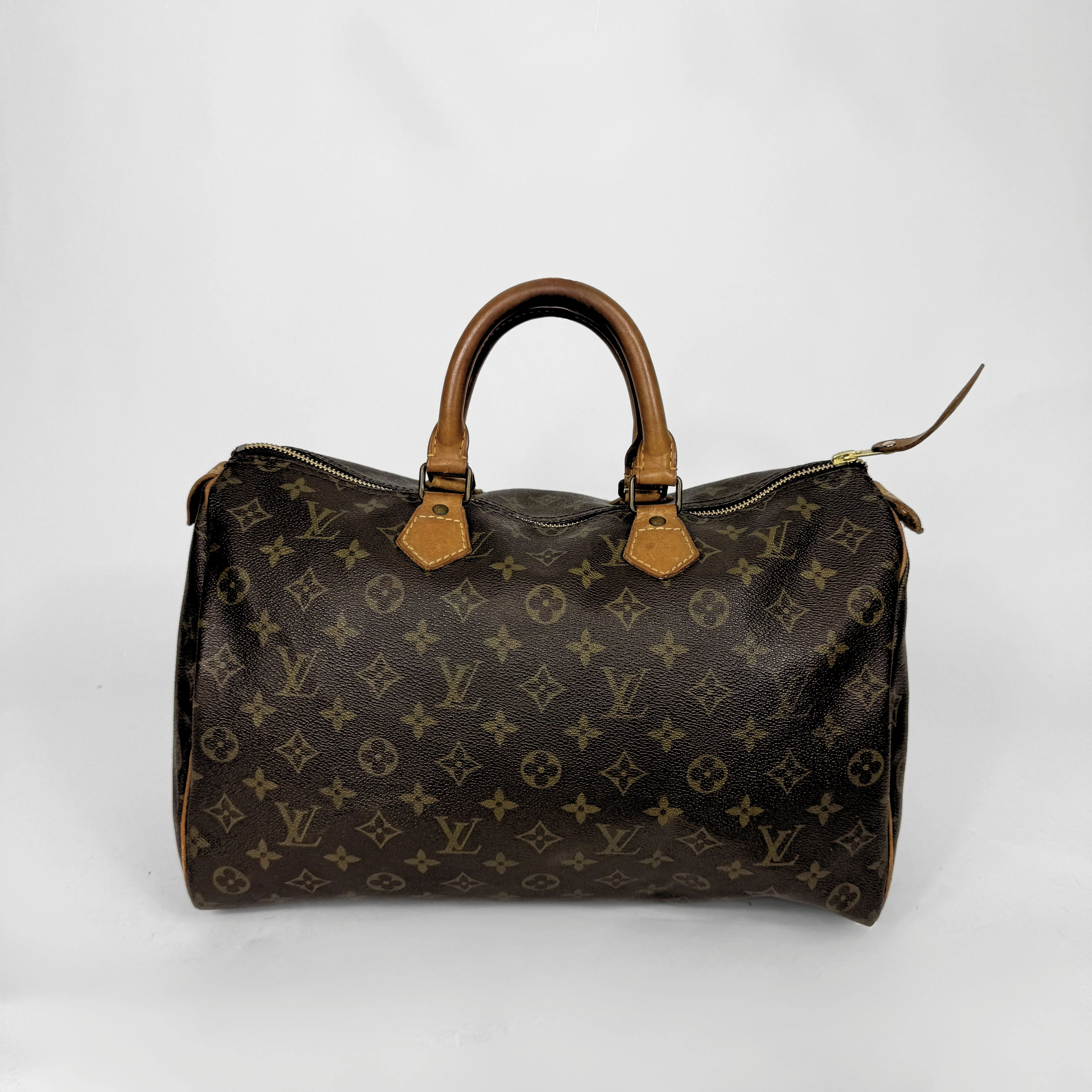 Brown handbag with monogram pattern on a white background