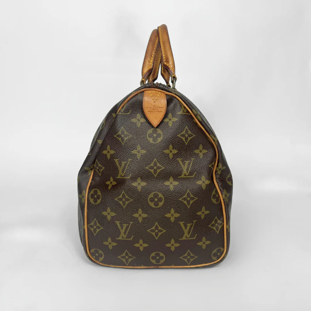 Brown handbag with monogram pattern on a white background
