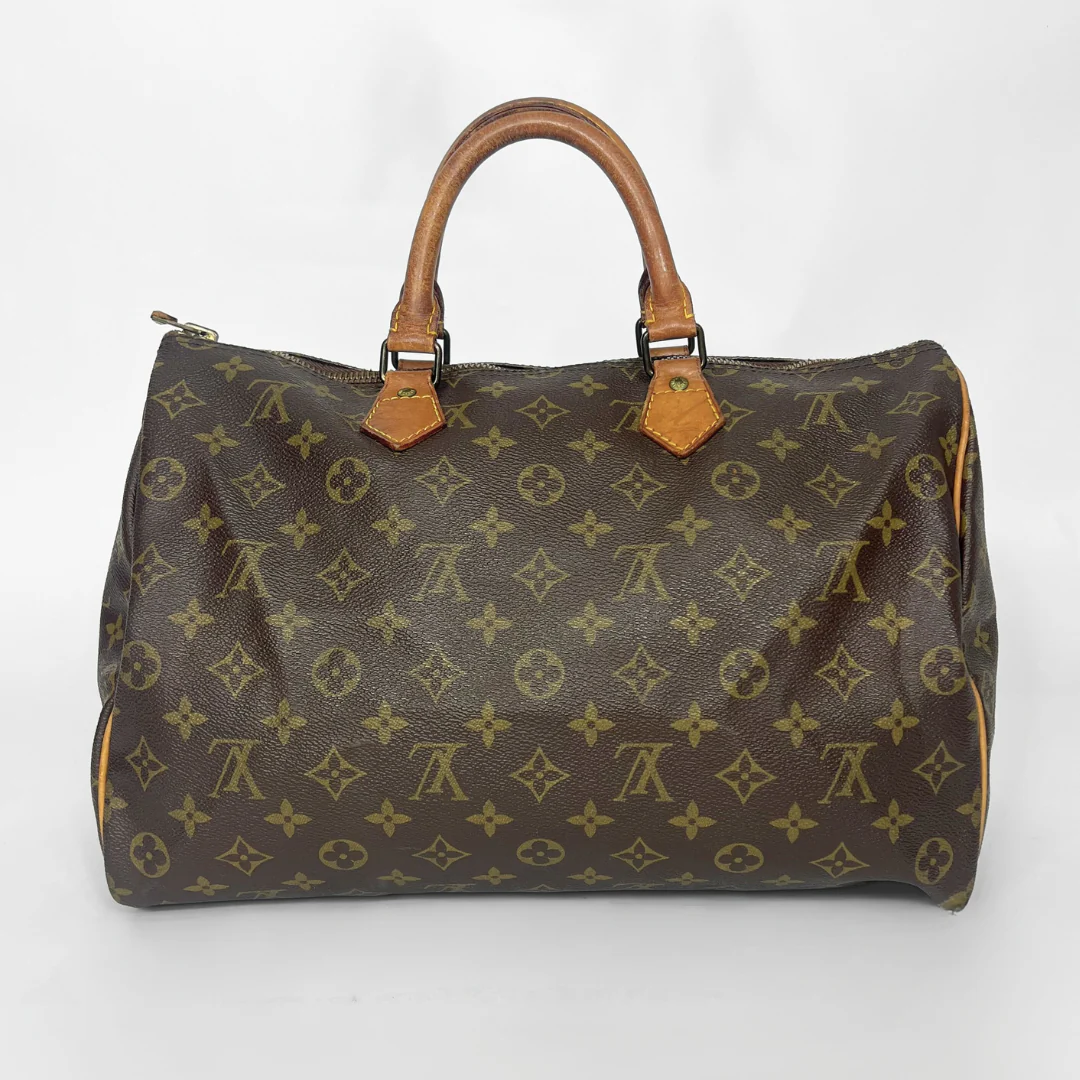 Brown handbag with monogram pattern on a white background