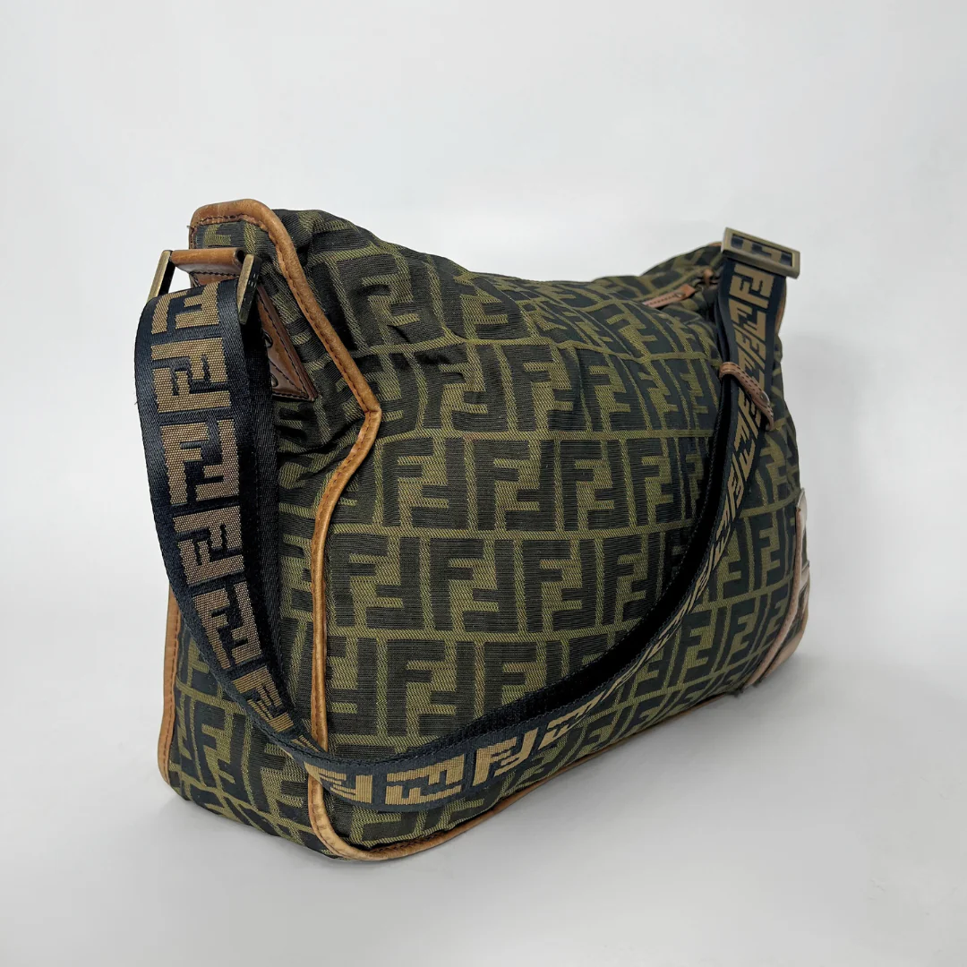 Vintage handbag with a prominent logo pattern on a white background