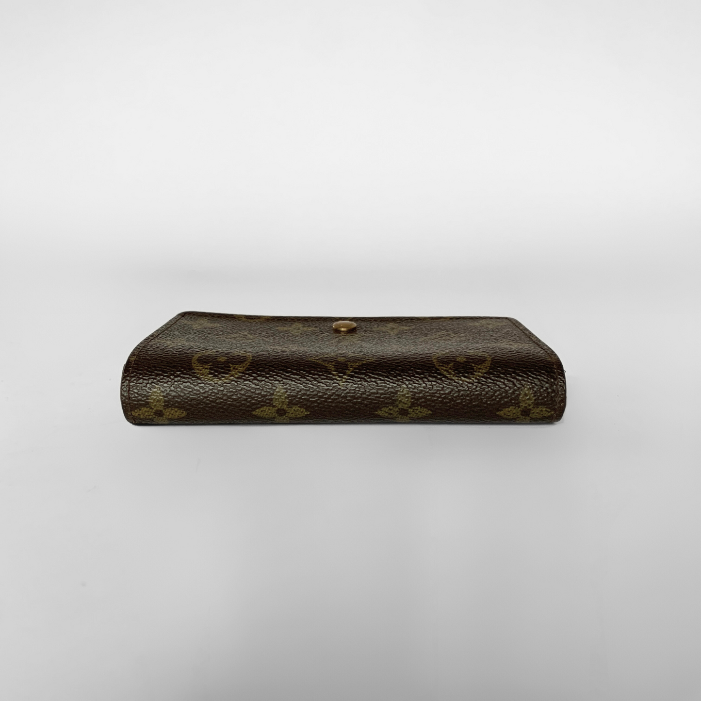 Louis Vuitton wallet with monogram pattern on a white background