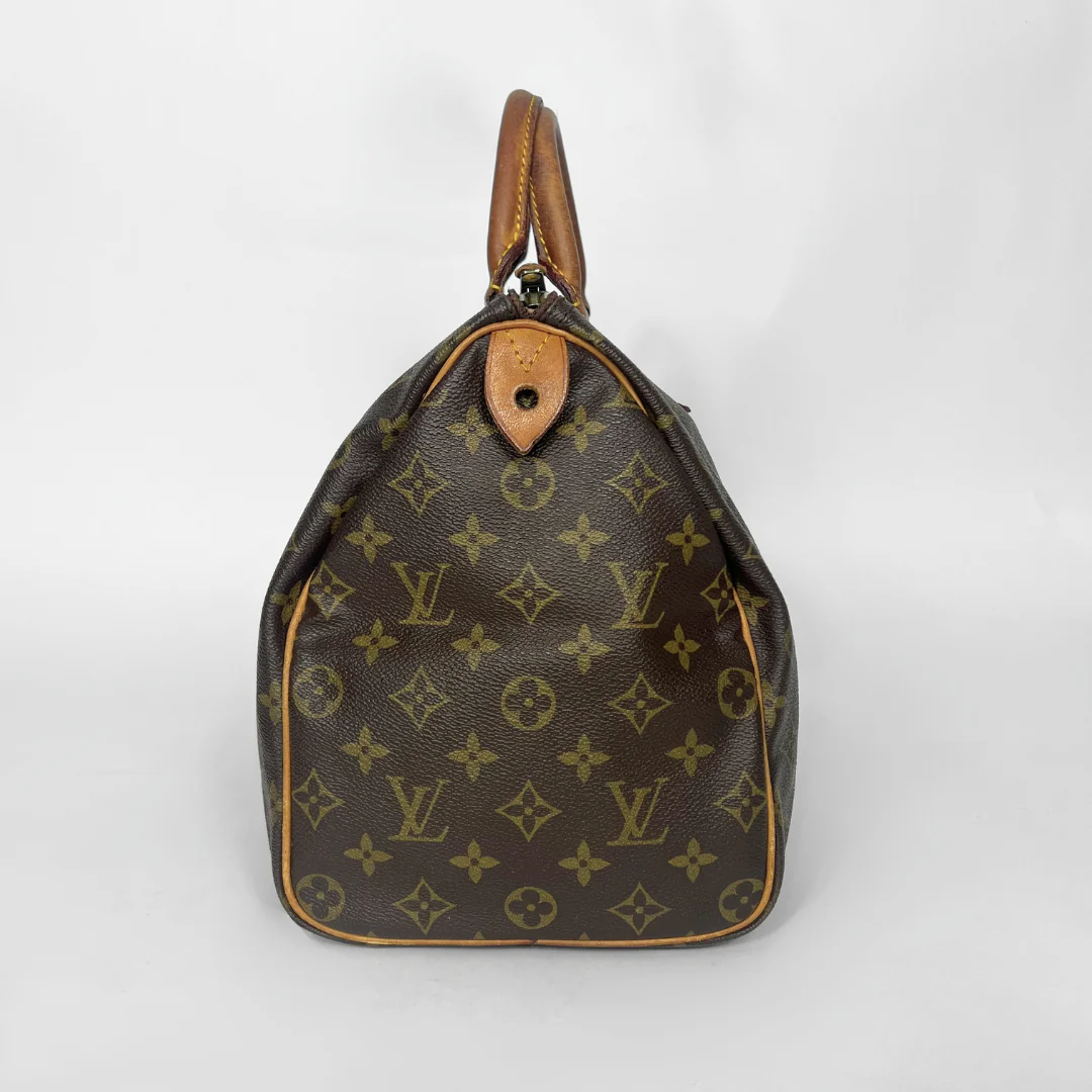 Brown Louis Vuitton handbag with monogram pattern on a white background